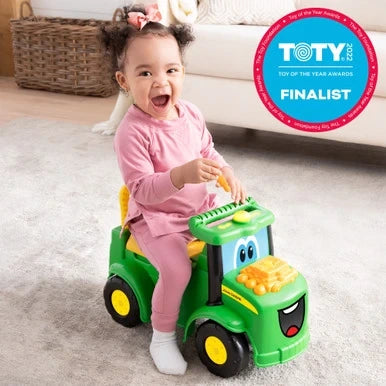 John Deere Johnny Tractor with smiling child riding and Toy of the Year finalist badge