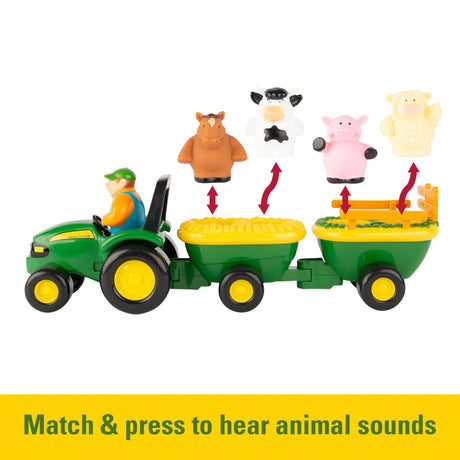 Side view of John Deere tractor with two wagons showing cow pig sheep and horse figures above the trailers with red arrows, with yellow banner text “Match & press to hear animal sounds”