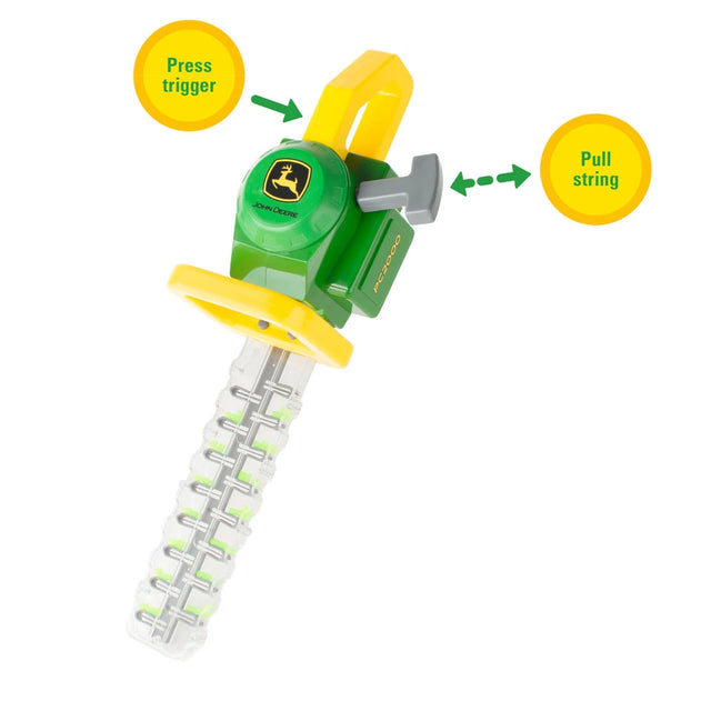 John Deere toy hedge trimmer with yellow callouts reading “Press trigger” and “Pull string” with arrows pointing to the grey trigger and grey pull handle