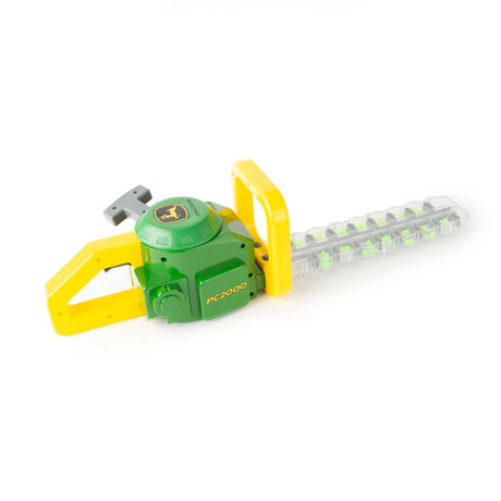 Side view of John Deere toy hedge trimmer showing yellow handle, grey pull handle, green body marked “PC2000” and clear blade section with green beads