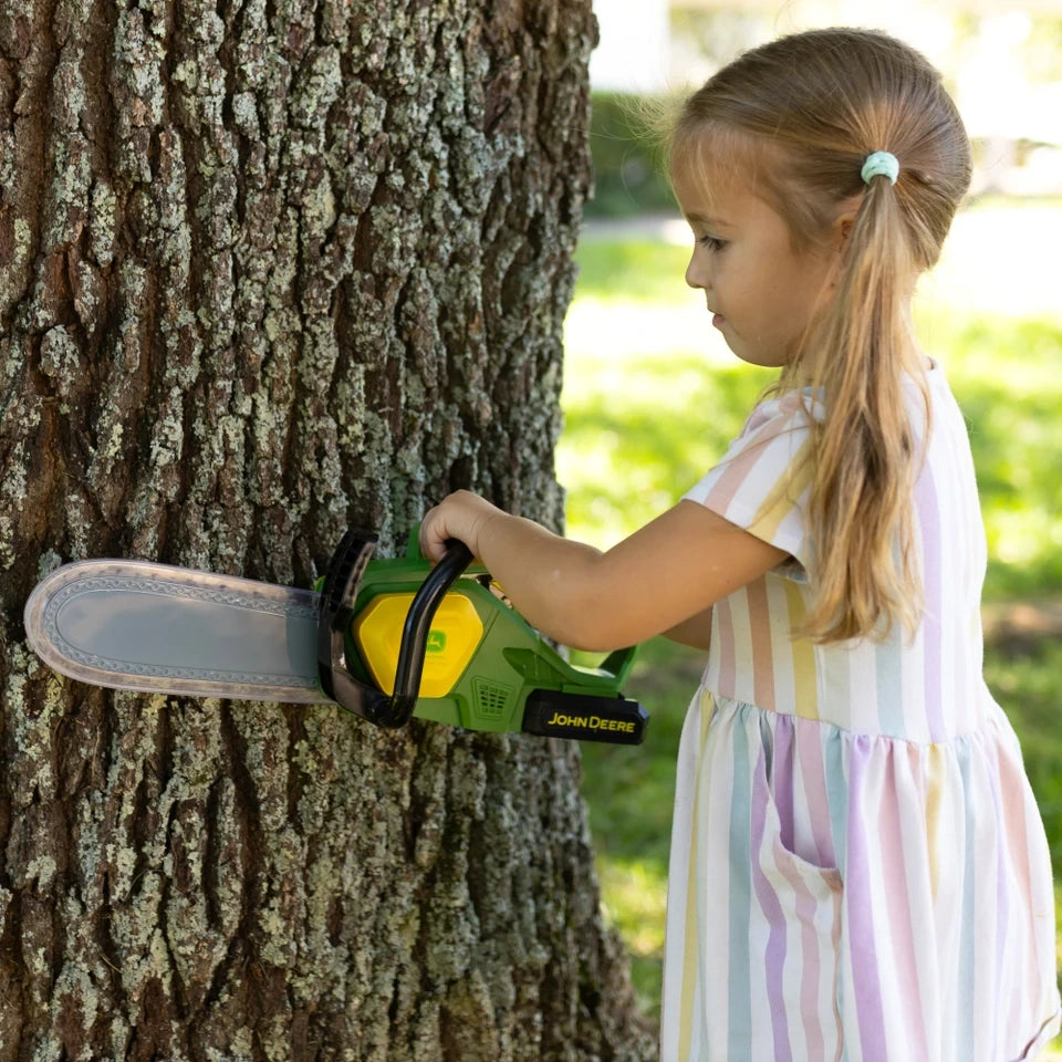 John Deere Motorised Chainsaw held against tree trunk by child using both handles