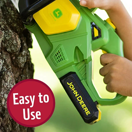 John Deere Motorised Chainsaw close view of rear grip and trigger while held against tree trunk