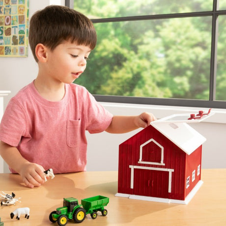 Child playing with John Deere Red Barn Farm Playset Model 47333 Ireland