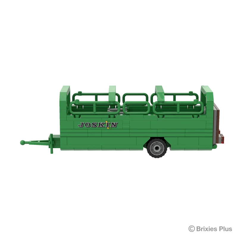 BRIXIES Plus Joskin Betimax livestock trailer in full side profile with the drawbar extending left, green side panels, open upper rails and single axle visible