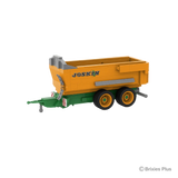 BRIXIES Plus Joskin Trans-KTP tipping trailer viewed from the front side with the green drawbar extending left, orange body and tandem axle wheels visible