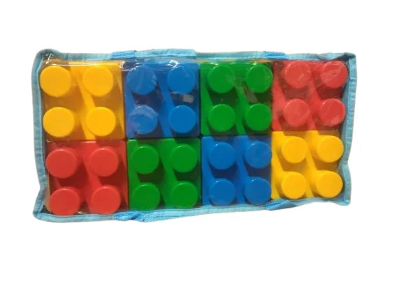 Top view of jumbo building blocks in bright red blue yellow and green arranged in a clear bag on a white background
