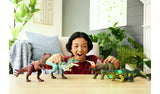 Jurassic World Wild Roar Metriacanthosaurus on a table with child playing with four Jurassic World dinosaurs