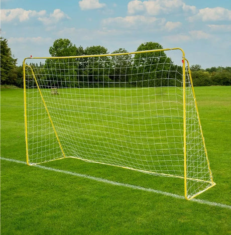 Yellow metal football goal with white netting on grass shown from an angled view