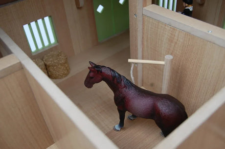 Inside view of Kids Globe wooden horse stable box with a horse figure and bale detail