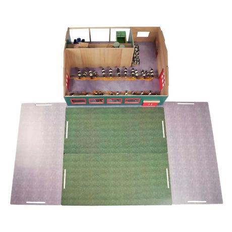 Overhead view of Kids Globe 1:32 wooden cattle farm interior showing cow stalls, hay bales and foldout pasture and yard play surfaces