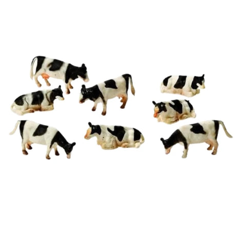 Kids Globe 1:87 black and white cow figures shown loose as a group