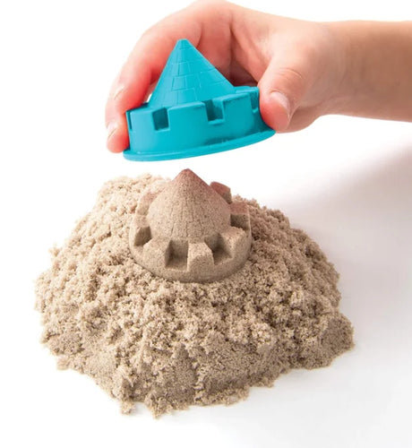 Hand revealing castle turret moulded in natural Kinetic Sand – Ireland