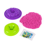 Kinetic Sand Surprise Takeout Treats with pink sand, green mould, purple mould and sprinkles