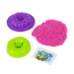 Kinetic Sand Surprise Takeout Treats with pink sand, green mould, purple mould and sprinkles