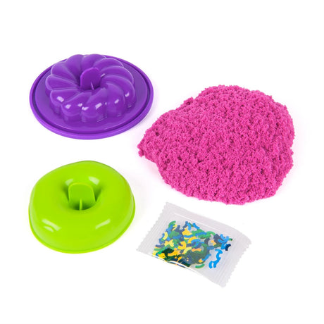Kinetic Sand Surprise Takeout Treats with pink sand, green mould, purple mould and sprinkles