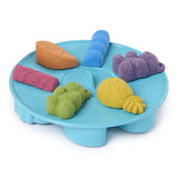 Blue tray holding orange, pink, green, yellow, blue and purple moulded Kinetic Sand shapes