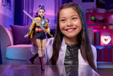 Child holding the KPop Demon Hunters HUNTR/X Rumi Doll with her purple hair, yellow jacket and sword