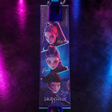 KPop Demon Hunters Takedown Folding Scooter deck showing HUNTR/X characters Mira, Rumi and Zoey with their names and the HUNTR/X logo against a dark background with pink and blue lighting