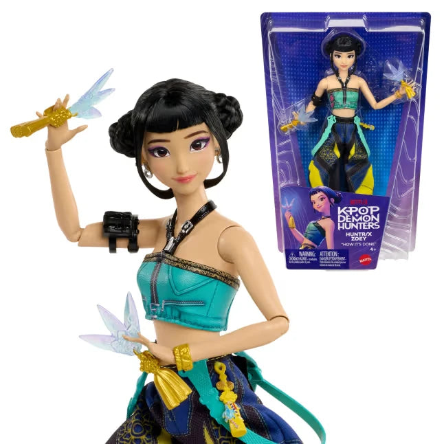 KPop Demon Hunters HUNTR/X Zoey Doll holding her Spirit Blades beside the retail packaging