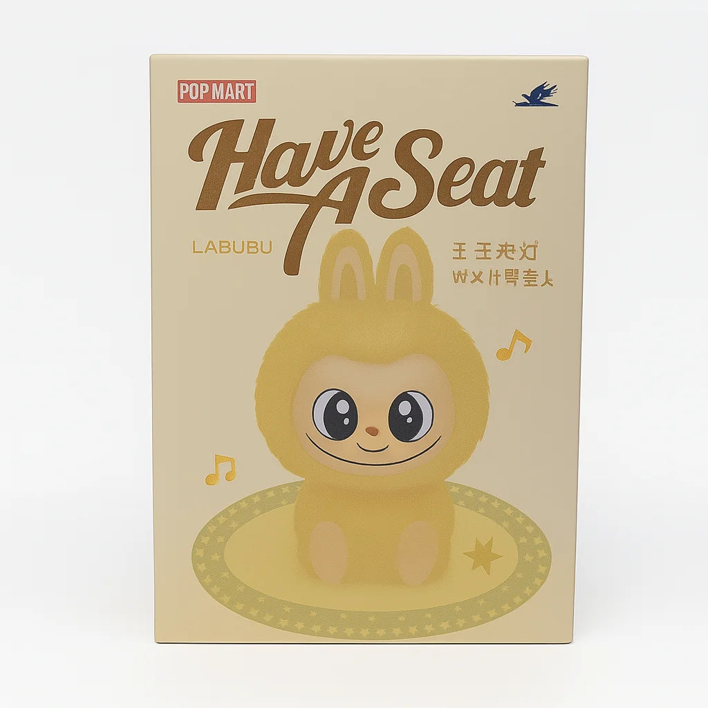 L Monster collectable toy box featuring a yellow bunny-suited character with wide eyes under ‘Have A Seat’ branding – Ireland