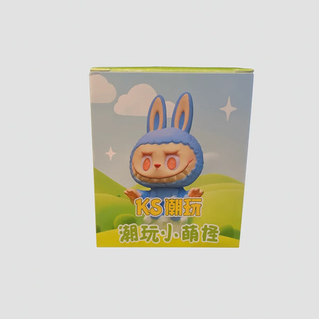 L Monsters collectable toy box with bunny costume character on green hills background – Ireland