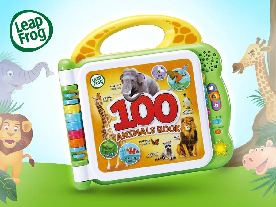 LeapFrog 100 Animals Book with yellow carrying handle and animal cover, surrounded by illustrated elephant, lion, giraffe and hippopotamus