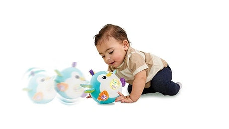 Baby crawling towards LeapFrog 123 Bounce with Me Penguin as it rolls forward
