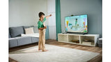 Child learning with LeapFrog LeapMove motion-based educational game on TV in Ireland.