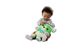Young child sitting on the floor pressing the interactive buttons on a LeapFrog My Best Pal Scout plush puppy