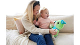 Mother holding a baby on a sofa while showing them the LeapFrog My Best Pal Scout interactive green puppy