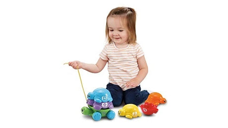 Child sitting with LeapFrog Nest & Count Turtle Tower and separate coloured turtles