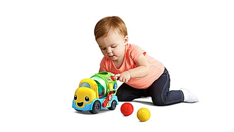 Child beside LeapFrog Popping Colour Mixer Truck with red and yellow balls