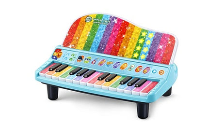 Angled view of LeapFrog Twinkle Lights Learning Piano showing green and yellow illuminated stars on its rainbow panel