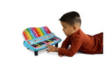 Young boy wearing a brown top and playing the colourful keys of a LeapFrog Twinkle Lights Learning Piano