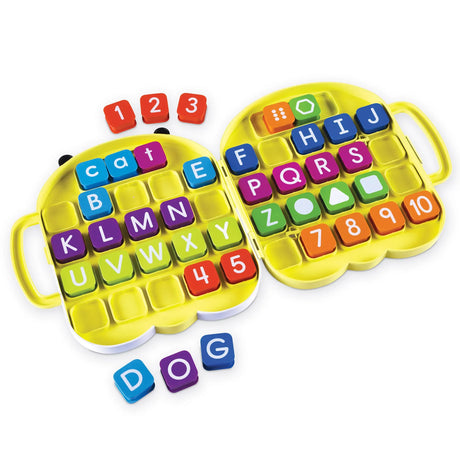 Open AlphaBee case showing letter, number, and shape tiles in grid layout – Ireland
