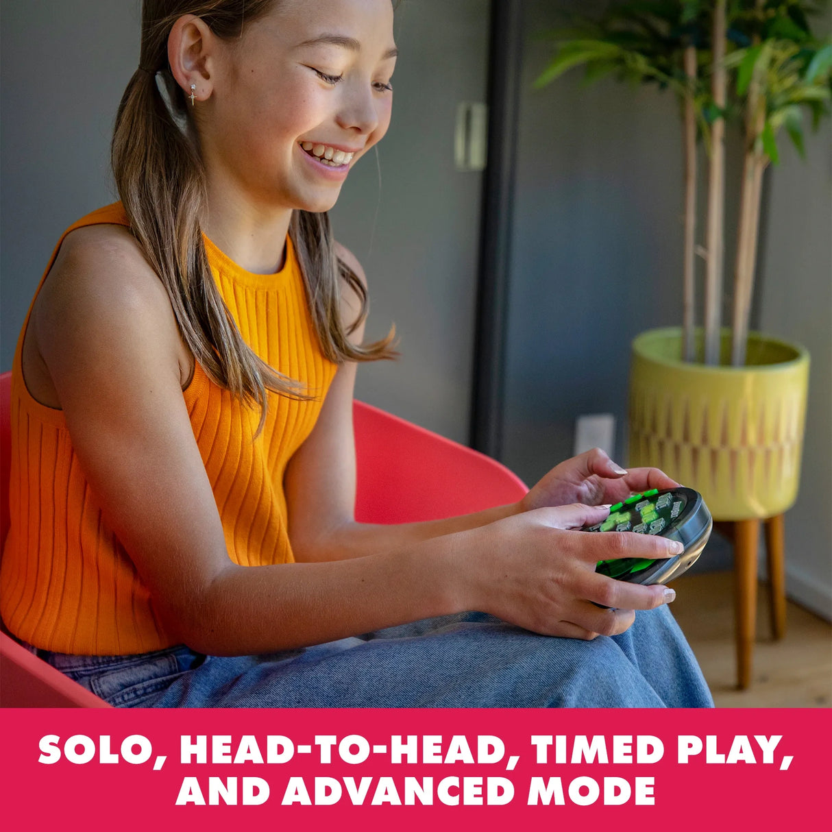 Girl playing Learning Resources BrainBolt handheld memory game