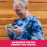 Adult playing Learning Resources BrainBolt handheld memory game outdoors