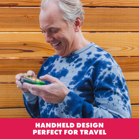 Adult playing Learning Resources BrainBolt handheld memory game outdoors