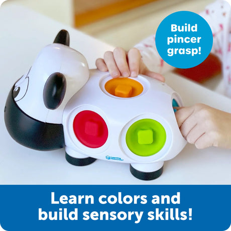 Toddler using Dottie Fine Motor Cow to practice colour and pincer grasp – Ireland