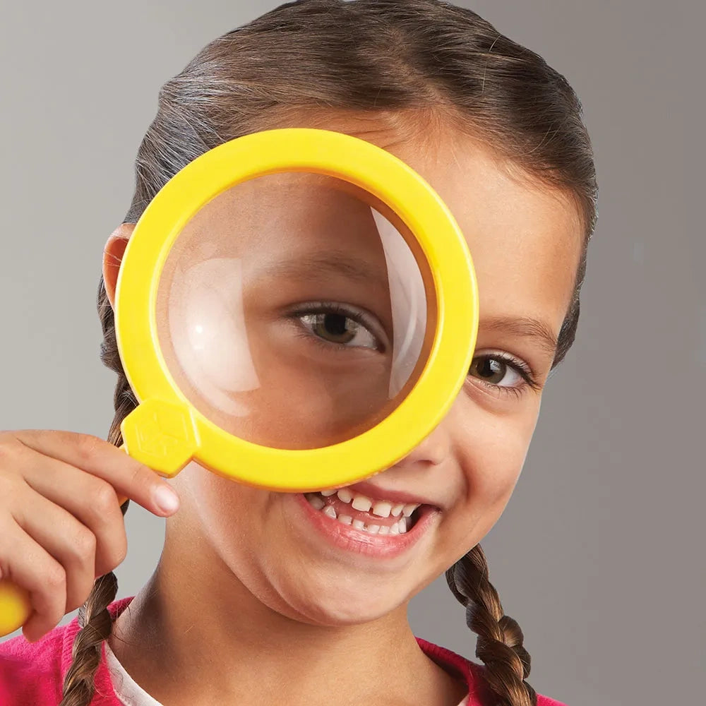 Child holding yellow Learning Resources Jumbo Magnifier