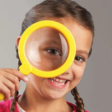 Child holding yellow Learning Resources Jumbo Magnifier