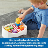 Child playing with Learning Resources Peeksville Barnyard Pounding Bench