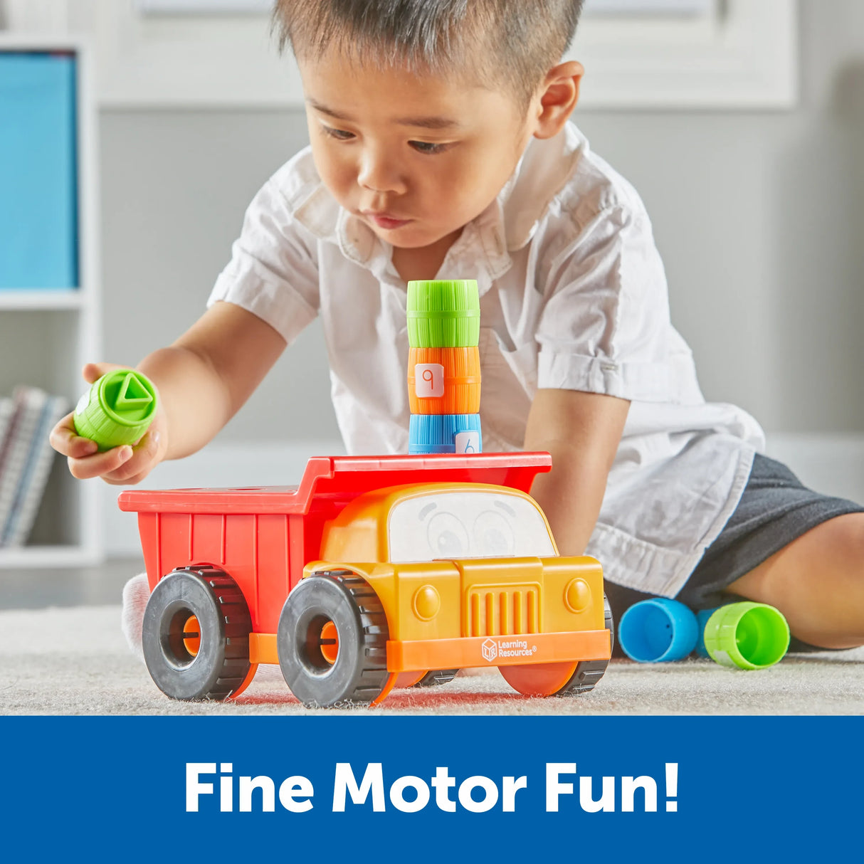 Child stacking barrels on Learning Resources Tony the Peg Stacker Dump Truck