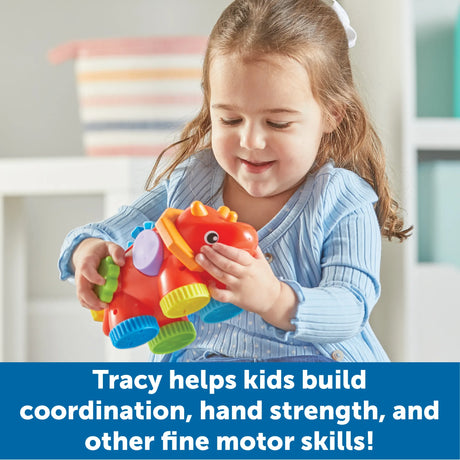 Child spinning and clicking parts of Tracy the Triceratops sensory toy – Ireland