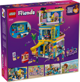 Back of LEGO Friends Heartlake City Friends Club House 42689 packaging showing the clubhouse interior, gaming area, climbing wall, slide, tandem bicycle and activity scenes.