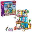 LEGO Friends Heartlake City Friends Club House 42689 retail box displayed beside the completed clubhouse with zip line, slide, minidolls, rooftop drone and tandem bicycle.