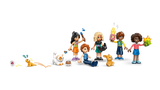 Five LEGO Friends minidolls from Heartlake City Friends Club House 42689 with gaming controller, popcorn, paintbrush, colourful accessories and three animal figures.