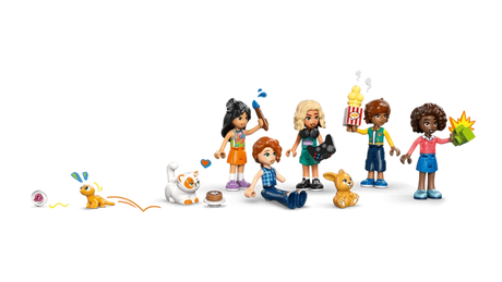 Five LEGO Friends minidolls from Heartlake City Friends Club House 42689 with gaming controller, popcorn, paintbrush, colourful accessories and three animal figures.
