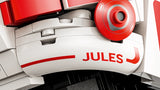 Close-up of the LEGO Charles Leclerc Ferrari helmet showing the red Jules lettering on a white curved panel with surrounding red and white LEGO pieces.