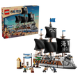 LEGO ONE PIECE Garp's Marine Battleship 75646 retail box displayed beside the completed warship with black sails, grey dog figurehead, Marine Victory Day market scene and minifigures.